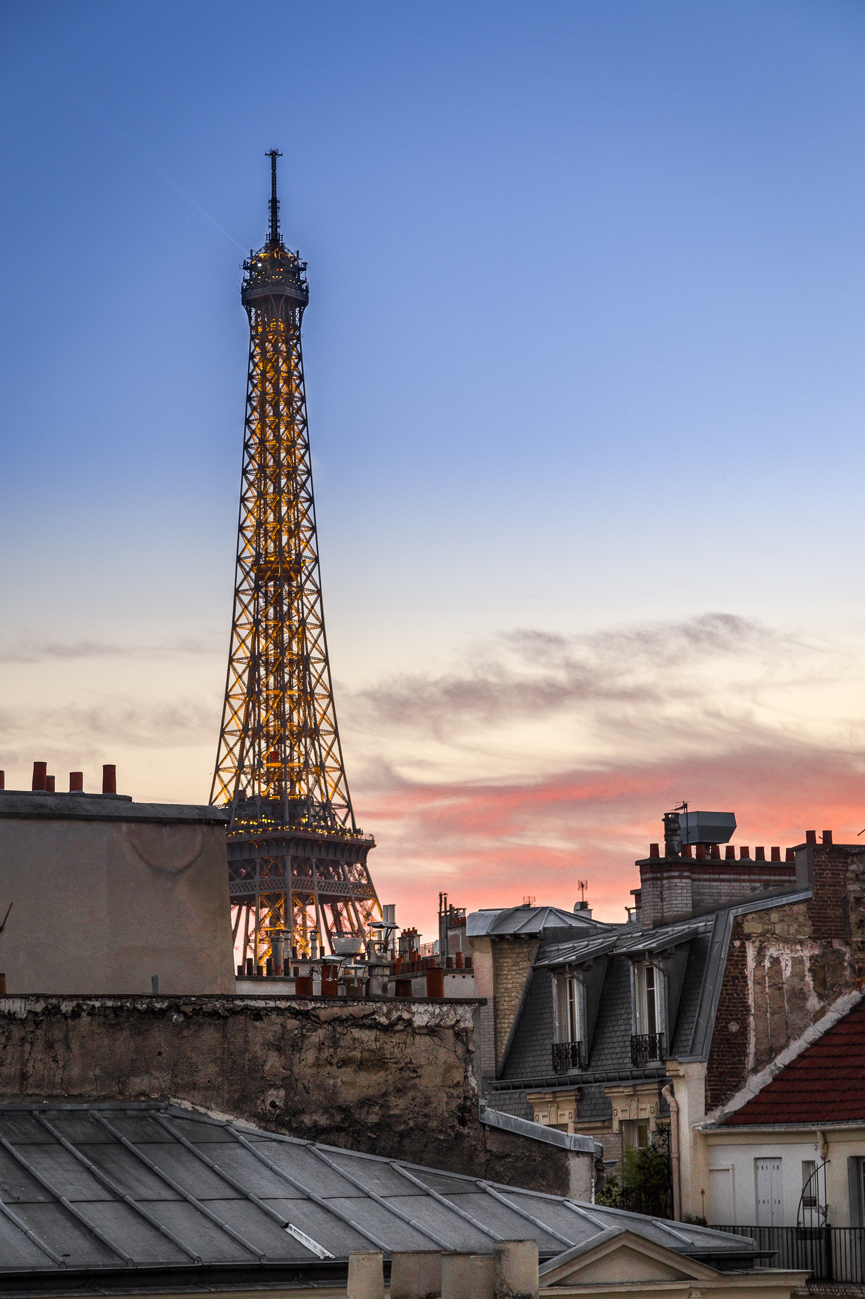 Vertical shot of the Eiffel Tower during a pink sunset in Paris, France A vertical shot of the Eiffel Tower during a pink sunset in Paris, France